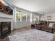 Bright living room with fireplace, large windows, and comfortable sofa with hardwood floors at 4013 Hamilton Mill Dr, Waxhaw, NC 28173