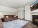 Cozy living room features hardwood floors, a fireplace, and comfortable brown sofa at 4013 Hamilton Mill Dr, Waxhaw, NC 28173