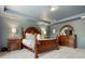 This spacious main bedroom boasts a large bed, matching dressers, soft carpet, and stylish blue walls and ceiling at 4013 Hamilton Mill Dr, Waxhaw, NC 28173
