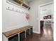 Well-organized mudroom with storage bench, hooks, and a view into the open kitchen, ideal for busy families at 4013 Hamilton Mill Dr, Waxhaw, NC 28173