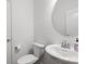 A simple, bright and clean powder room with a pedestal sink and oval mirror at 4013 Hamilton Mill Dr, Waxhaw, NC 28173