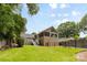 Backyard view with green grass, mature trees, a deck, and pool at 4024 Tyndale Ave, Charlotte, NC 28210