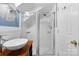 Bathroom featuring a marble sink and a modern glass-enclosed shower, blending style and functionality at 4024 Tyndale Ave, Charlotte, NC 28210