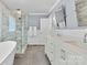 Bathroom showcasing dual sinks, a glass shower and a stylish vanity with marble countertops at 4024 Tyndale Ave, Charlotte, NC 28210