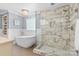 Modern bathroom with a freestanding tub, glass enclosed shower, and elegant tile work at 4024 Tyndale Ave, Charlotte, NC 28210