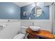 Stylish bathroom with a vessel sink, modern fixtures, beadboard paneling, and blue painted walls at 4024 Tyndale Ave, Charlotte, NC 28210