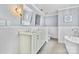 Elegant bathroom featuring dual sinks, marble countertops, mirrors and a soaking tub at 4024 Tyndale Ave, Charlotte, NC 28210