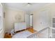 Comfortable Bedroom featuring hardwood floors, a changing table, and a plush rug at 4024 Tyndale Ave, Charlotte, NC 28210