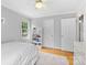 Cozy bedroom with a white bed frame, floral wallpaper accent and natural light, creating a warm and inviting space at 4024 Tyndale Ave, Charlotte, NC 28210