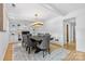 Bright dining room with a decorative chandelier, built-in shelving, and an elegant dining set at 4024 Tyndale Ave, Charlotte, NC 28210
