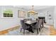 Formal dining room featuring a large table, elegant chairs, a modern chandelier, and a fireplace at 4024 Tyndale Ave, Charlotte, NC 28210