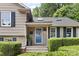 Inviting front porch features a blue door, brick steps, and manicured hedges for added curb appeal at 4024 Tyndale Ave, Charlotte, NC 28210