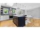 Bright kitchen showcasing a central island, stainless steel appliances, and a cozy dining nook at 4024 Tyndale Ave, Charlotte, NC 28210