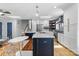 Spacious kitchen featuring an island with seating, stainless steel appliances, and an open layout to the living area at 4024 Tyndale Ave, Charlotte, NC 28210