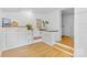 Bright laundry room with cabinets, white brick walls and natural hardwood floors at 4024 Tyndale Ave, Charlotte, NC 28210