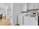 Laundry room with white cabinets, a washer and dryer set, and access to the basement at 4024 Tyndale Ave, Charlotte, NC 28210