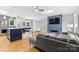 Bright living room featuring a modern fireplace, hardwood floors, and a stylish island with seating at 4024 Tyndale Ave, Charlotte, NC 28210