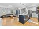 Open concept living room and kitchen with stainless steel appliances and an island with a breakfast bar at 4024 Tyndale Ave, Charlotte, NC 28210