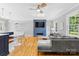 Spacious living room with hardwood floors, a modern fireplace, and large windows offering natural light at 4024 Tyndale Ave, Charlotte, NC 28210