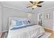 Bright main bedroom featuring a queen-size bed with blue accents and an ensuite bath at 4024 Tyndale Ave, Charlotte, NC 28210