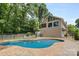 Backyard pool view, with a sun deck, landscaped yard, and a partial view of the house at 4024 Tyndale Ave, Charlotte, NC 28210
