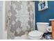 Bathroom showcasing a toilet, shower with patterned curtain, and a storage shelf at 4075 Clover Nw Rd, Concord, NC 28027