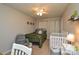 Bedroom with dark green comforter, ceiling fan, a chair, and a crib at 4075 Clover Nw Rd, Concord, NC 28027