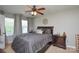 Cozy bedroom with a ceiling fan, a queen-sized bed, and warm neutral decor at 4075 Clover Nw Rd, Concord, NC 28027
