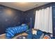 Unique bedroom features constellation wall decor, blue sofa, and a cozy rug at 4075 Clover Nw Rd, Concord, NC 28027