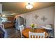 Open dining area with wood table adjacent to kitchen, with modern appliances at 4075 Clover Nw Rd, Concord, NC 28027