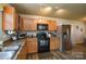 Well-lit kitchen features stainless steel appliances, wood cabinets, and granite countertops for a modern, eat-in space at 4075 Clover Nw Rd, Concord, NC 28027
