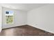 Well-lit bedroom with hardwood floors and a large window providing a view of the outdoors at 4315 Palm Dr, Denver, NC 28037