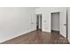 Spacious room with white walls, trim, with wood-look flooring, two doors, and a closet at 4315 Palm Dr, Denver, NC 28037