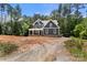 New home with a front porch, gray siding, set on a large lot with mature trees at 4315 Palm Dr, Denver, NC 28037