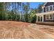 New construction home with covered porch and wooded surroundings, ready for landscaping at 4315 Palm Dr, Denver, NC 28037