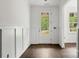 Bright foyer with wainscoting, hardwood floors, and front door view at 4315 Palm Dr, Denver, NC 28037