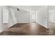 Large open living room with hardwood floors, white walls and ample natural light streaming through the window at 4315 Palm Dr, Denver, NC 28037