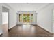 Bright living room with hardwood floors, a sliding glass door, and ample natural light streaming through the windows at 4315 Palm Dr, Denver, NC 28037