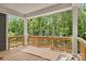 Covered porch with natural wood deck and wooded views at 4315 Palm Dr, Denver, NC 28037