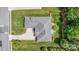 Aerial view of a well-maintained property showcasing the roof, landscaping, and patio area at 4409 Winder Trl, Gastonia, NC 28056