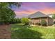 Well-manicured backyard featuring lush greenery, mature trees, and a serene atmosphere at 4409 Winder Trl, Gastonia, NC 28056