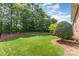 Beautiful backyard with lush lawn and mature trees, perfect for outdoor enjoyment at 4409 Winder Trl, Gastonia, NC 28056