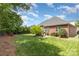 Spacious backyard with lush lawn, manicured landscaping, and patio area at 4409 Winder Trl, Gastonia, NC 28056