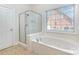 Bathroom featuring a glass-enclosed shower and soaking tub with jetted tub at 4409 Winder Trl, Gastonia, NC 28056