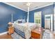 Stylish bedroom with a four-poster bed and hardwood floors at 4409 Winder Trl, Gastonia, NC 28056