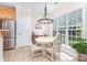 Sunlit breakfast nook featuring tile floors, a charming table set, and large windows with a view at 4409 Winder Trl, Gastonia, NC 28056