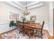 Elegant dining room featuring hardwood floors, crown molding, and a stylish chandelier at 4409 Winder Trl, Gastonia, NC 28056