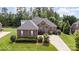 Beautiful brick home featuring manicured landscaping, a paved driveway, and classic shutters at 4409 Winder Trl, Gastonia, NC 28056