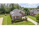 Aerial view of a brick home showcasing the roof, landscaping, and the surrounding neighborhood at 4409 Winder Trl, Gastonia, NC 28056