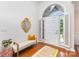 Bright foyer with hardwood floors, bench seating, decorative mirror, and ample natural light at 4409 Winder Trl, Gastonia, NC 28056